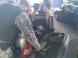 Policiais militares vistoriando veículo com fundo falso.