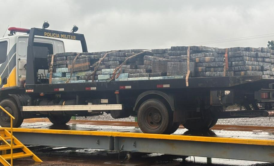 Após buscas detalhadas, os militares estaduais localizaram aproximadamente 5.100 quilos de maconha escondidos sob um carregamento de mandioca